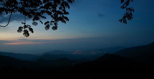 Scenic view of silhouette mountains against sky at sunset