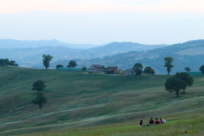 Scenic view of field and mountains against sky