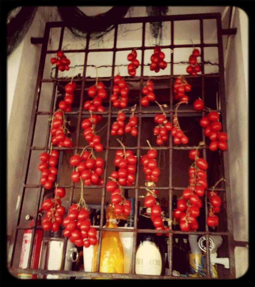 red, indoors, transfer print, window, glass - material, food and drink, freshness, auto post production filter, large group of objects, hanging, flower, abundance, fruit, transparent, no people, in a row, still life, arrangement, food, home interior