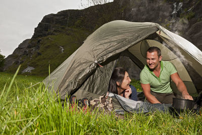 Mature couple cooking in tent in the uk