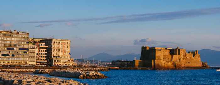 Naples view of castel dell ovo at sunset in the bay of naples italy