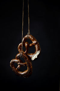 Close-up of rusty chain against black background