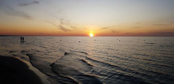 Scenic view of beach against sky during sunset