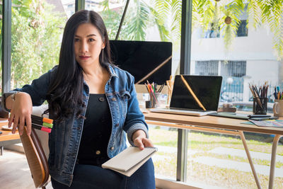 Young woman sitting on table