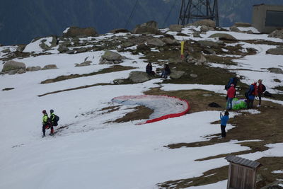 People walking on snow covered mountain