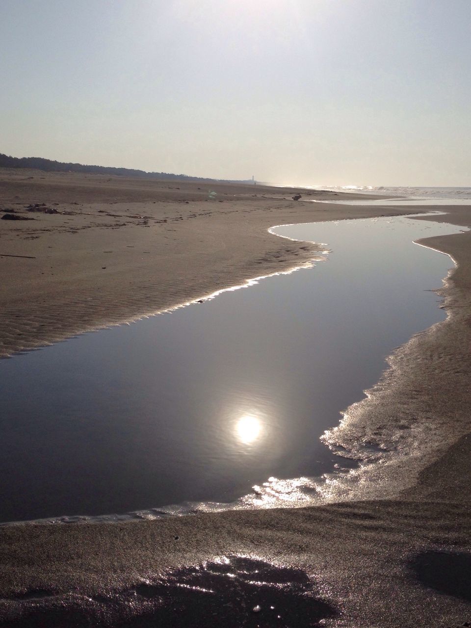 water, tranquil scene, sea, tranquility, beach, scenics, beauty in nature, shore, nature, sand, reflection, horizon over water, clear sky, sky, coastline, idyllic, sun, sunlight, outdoors, remote