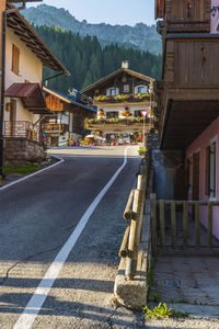 Road amidst buildings and houses in city