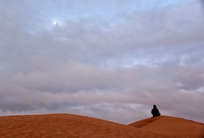 Man standing on desert against sky