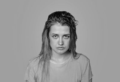 Portrait of beautiful young woman against white background