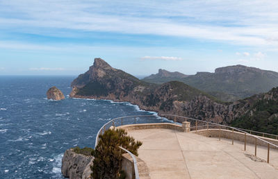 Scenic view of sea and mountains against sky