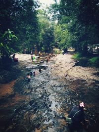 Group of people sitting on land by water