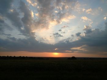 Scenic view of field against sky during sunset