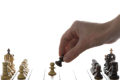 Low angle view of chess playing on white background