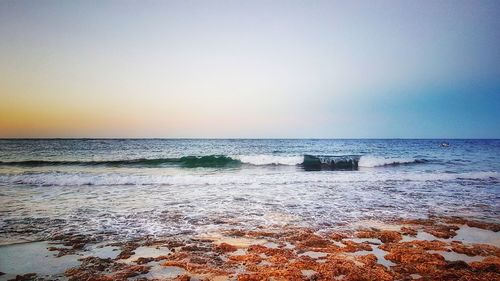 Scenic view of sea against clear sky during sunset