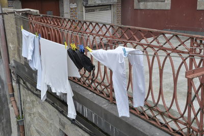 Rear view of clothes drying on railing against building