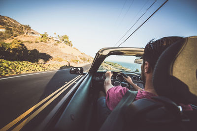 Rear view of people traveling in car