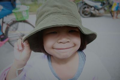 Portrait of cute girl wearing hat outdoors