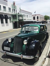 Cars on street against buildings in city