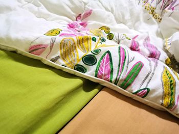 High angle view of multi colored fabric on bed
