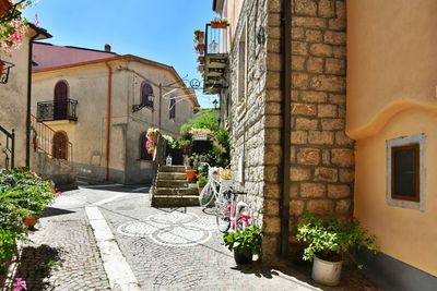 A narrow street among the old houses of greci, a village in the campania region, italy.