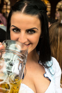 Portrait of young woman holding beer glass during oktoberfest