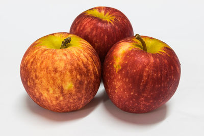 Close-up of apples on table against white background