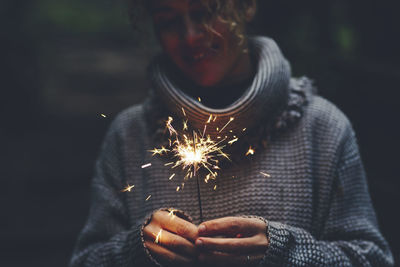 Portrait of woman holding sparkler