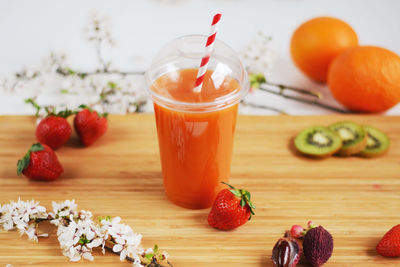 Juice amidst fruits on cutting board at home