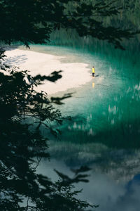 Reflection of person in lake