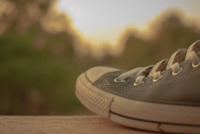 Close-up of cropped shoe against blurred background