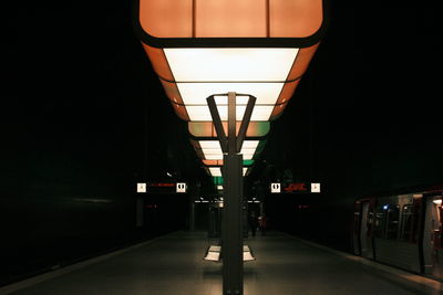 Illuminated underground walkway at night