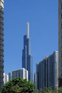 Modern buildings against clear blue sky