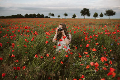 Woman photographing nature at sunset 