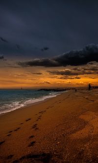 Scenic view of beach against sky during sunset