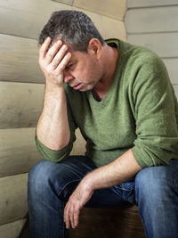 Midsection of man sitting at home