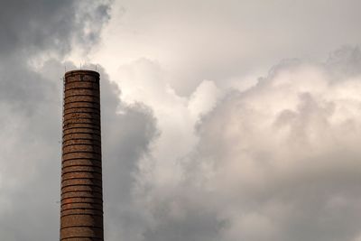 Low angle view of smoke stack against sky