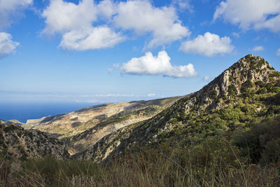 Scenic view of sea and mountains against sky