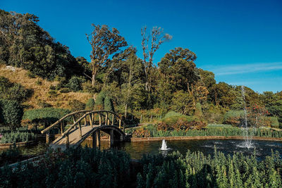 Arch bridge over river against blue sky