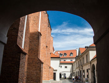 Low angle view of buildings in town against sky