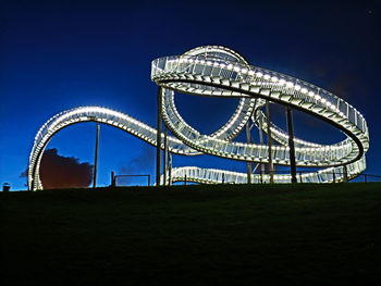 Low angle view of illuminated tiger and turtle against sky