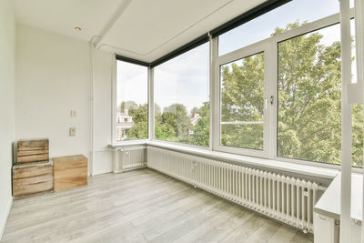 Rear view of woman standing by window