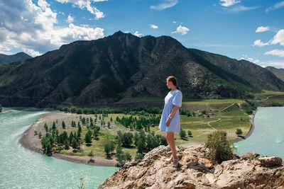 Woman standing on mountain against sky