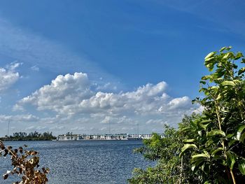 Scenic view of sea by buildings against sky