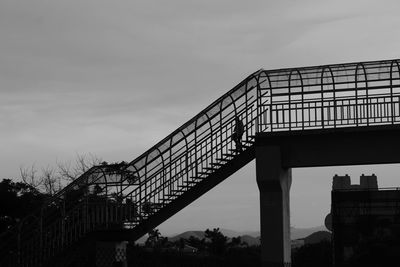 Person walking trough a lonely pedestrian bridge.