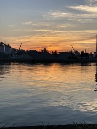 Silhouette boats in sea against sky during sunset