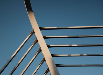 Low angle view of bridge against clear blue sky