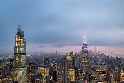 New york skyline from the top of the rock  in rockefeller center at night with clouds in the sky