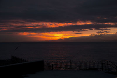 Scenic view of sea against orange sky