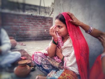 Women sitting outside building