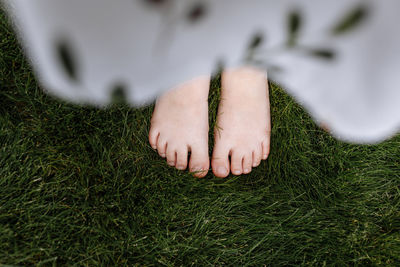 Low section of woman standing on grass